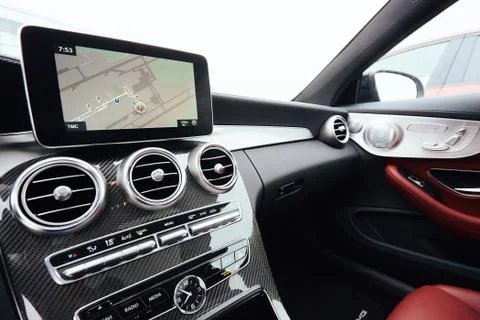 View from inside a car on a part of dashboard with a navigation unit and blurred Stockfoto's