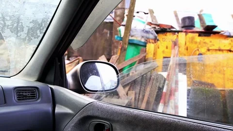 A view from inside a car, with raindrops visible on the window and side mirror, Stock Footage 326748934
