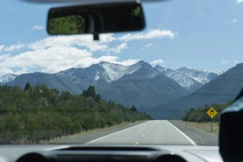 View from inside a car on the road to the mountain landscape. Stock Photos