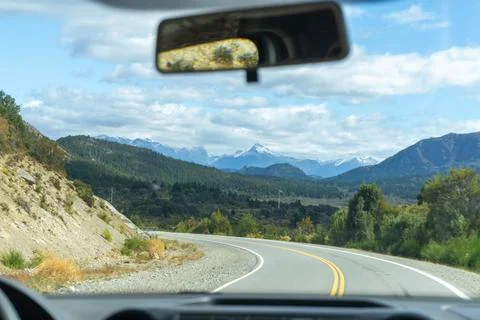 View from inside a car on the road to the mountain landscape. Stock Photos