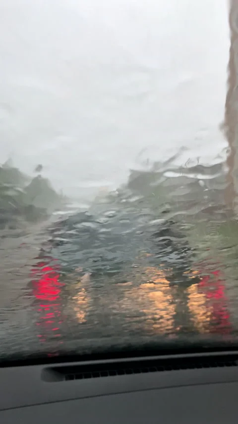 View from inside the car steering car at rain storm Stock Footage 200762366