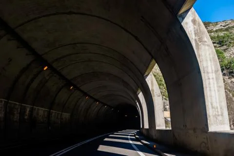 The view from inside a car tunnel through the Spanish Pyrenees mountains with Stock Photos