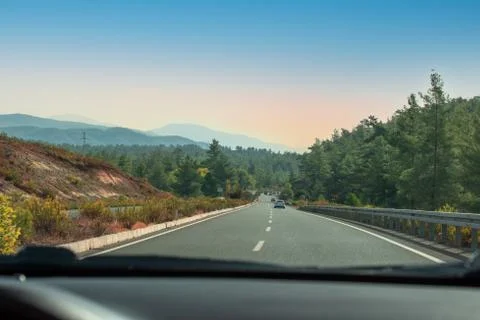 View from inside the car. View from the windshield of a car driving along a s Stock Photos