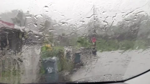 The view from inside the car when it rains heavily in the monsoon season Stock Footage 321863898