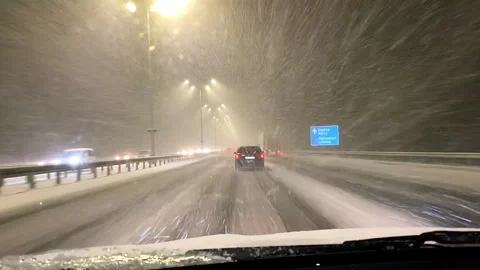 View from inside car window,windscreen,windshield driving on road at heavy snows Stock Footage 299435138
