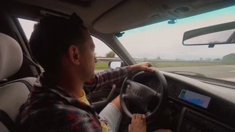 View from inside car, young man sitting behind wheel driving car Stock Footage 218379233