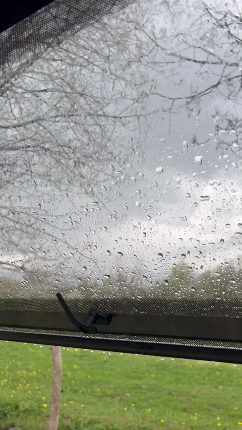 View from inside a caravan with an open window during a rainy and thunderou.. Stock Footage 281064895
