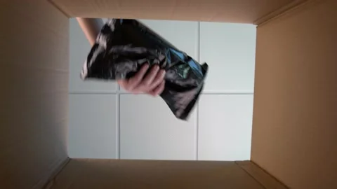 View from inside of cardbox, caucasian man opens box stretching his hand inside Stock Footage 144135494