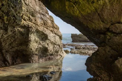 A View from inside a Cave on the Beach Stock Photos