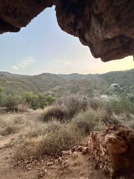 A view from inside of a cave in the mountains Stock Photos