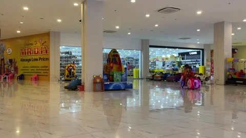 View inside the chilled shopping mall kids riding toy car, Pattaya, Thailand Stock Footage 245335549