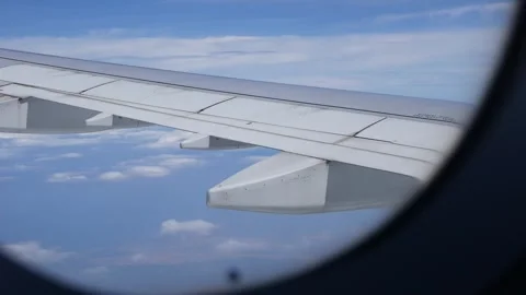 View from inside a commercial aircraft, from the window you can see the wing of Stock Footage 312336051