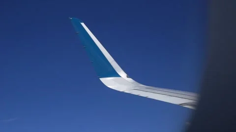 View from inside a commercial aircraft, from the window you can see the wing of Video stock 312336108