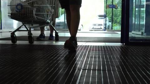 A view from inside a commercial building showing an entrance area where vehicles Stock Footage 313930984