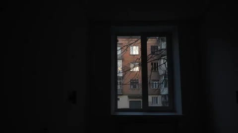 View from inside the dark room through the window to glare of the sun is reflect Stock Footage 263115504