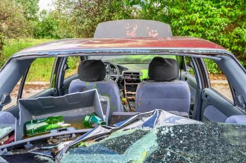 View of inside of destroyed abandoned car with broken car glasses Stock Photos