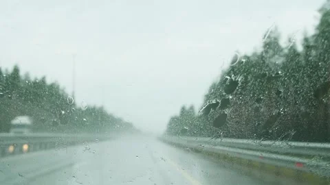 View from the inside of a driving car with working windshield wipers during rain Stock Footage 278506538