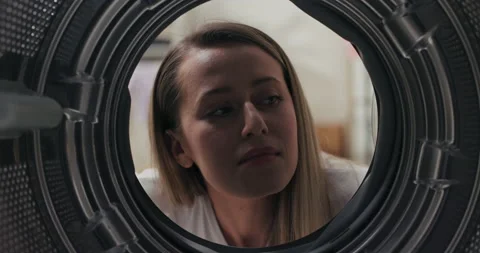 View from inside the drum, a woman has bought a new washing machine looks at it Stock Footage 199834224