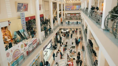 View from inside the elevator of a large shopping mall. A crowd of people is  Stock Footage 87452271