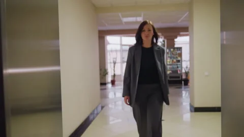 View from Inside Elevator with Woman in Business Attire in Corporate Office Stock Footage 306497450