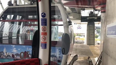 View from inside the Emirates Air Line carriage leaving the Royal Victoria Docks Stock Footage 113616270