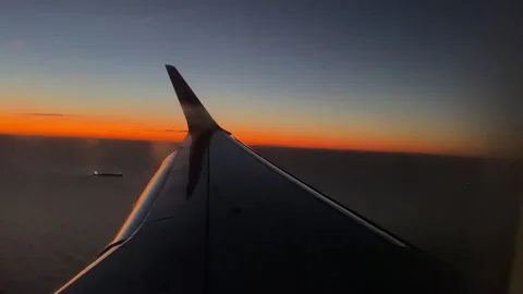 View from inside of flying airplane on wing with blinking light in breathtaking Stock-Footage 317257062
