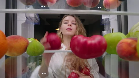 View from inside the fridge - woman open... Stock Video Pond5