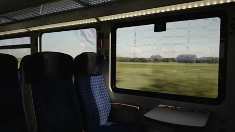 View from inside a German regional train in Bavaria, looking out at bright green Видео 340891286