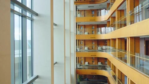 View from inside a glass elevator descending through a modern hotel Stock Footage 315914852