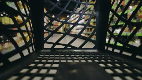 View from inside handheld shopping plastic cart basket in mall center. Empty Stock Footage 131229956