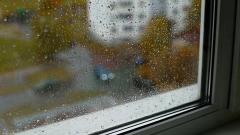 View from inside the house to the street, raindrops on the windowsill and double Stock Footage 256875944