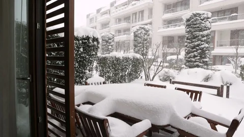 View from inside of a luxury house, windows open and snowing outside. Stock Footage 76759329
