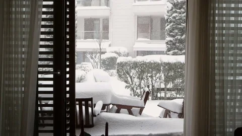 View from inside of a luxury house, windows open and snowing outside Stock Footage 76760303