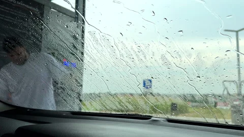 View from inside of man washing car Stock Footage 254149534