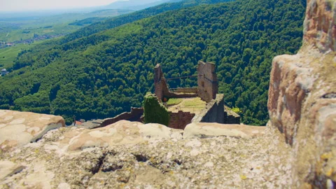 View from inside medieval castle ruins overlooking forested hills Stock Footage 327569254