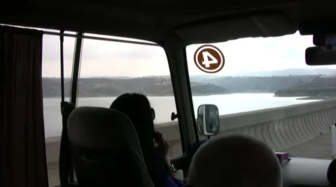 View from inside minibus crossing road over a reservoir in northern Cyprus Stock Footage 39784360