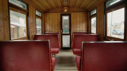 View inside a Mocanita train carriage with red seats and wooden walls Stock Footage 346718027