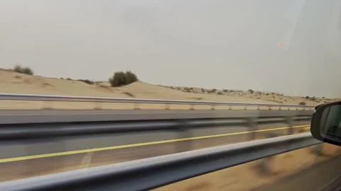 View from inside moving car along desert highway, with guardrail, lane Stock Footage 345437400