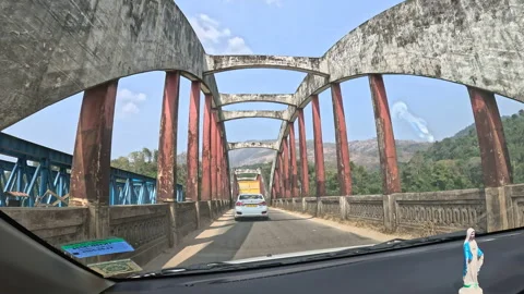 View from inside a moving car while crossing a bridge in Kerala Stock Footage 327207938