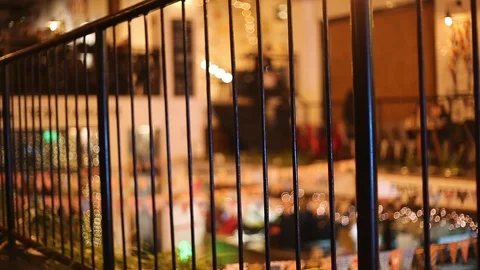 View inside an old restaurant. Black fence on foreground. Resting people on the Video stock 106592538