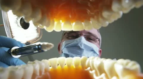 View from inside an open mouth getting a shot of novocaine Stock Footage 11629867