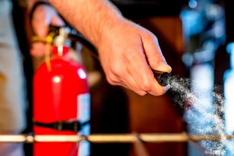 View from inside an oven with selective focus on a extinguisher being aimed at Foto stock