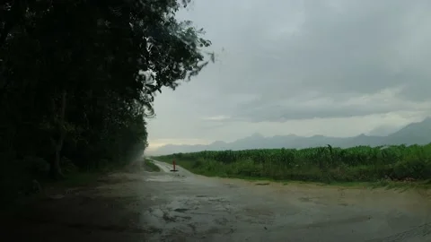 View from inside a parked car while rain falls on the windshield Stock Footage 220794647