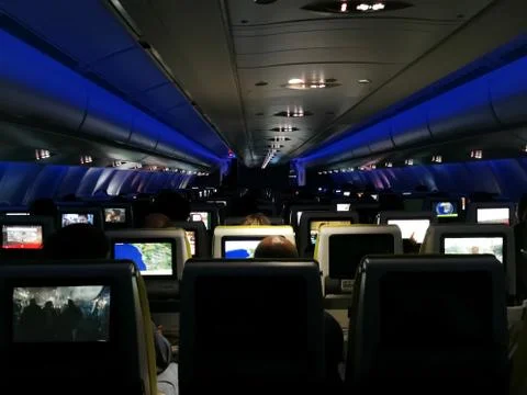 View from inside the plane in mid-flight, low lights, with blue LEDs and emer Stock Photos