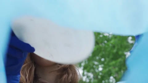 View from inside a plastic bag. Environmental volunteer young woman collecting Stock Footage 200812056