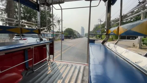 View inside public minibus pick up truck empty seats driving on road. Thailand Stock Footage 225119074