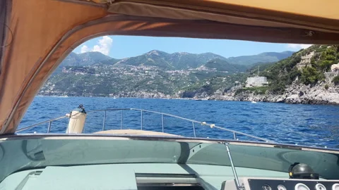 View from inside of rocking boat on beautiful Amalfi coastline during summer Video stock 323947332