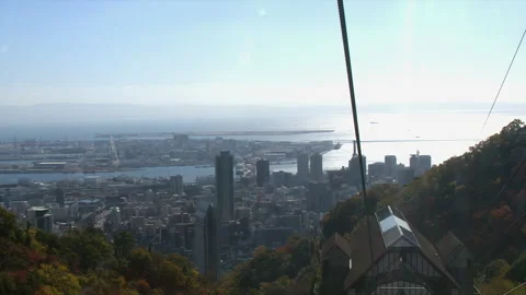 View from inside ropeway cable car descending to mid station above city Stock Footage 327629484