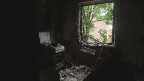 View from inside ruined and burnt kitchen after being hit by russian missile Stock Footage 220599011