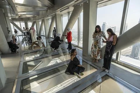 View inside the Sky View skyscraper. Tourists walk on the glass floor and t.. Stock Photos